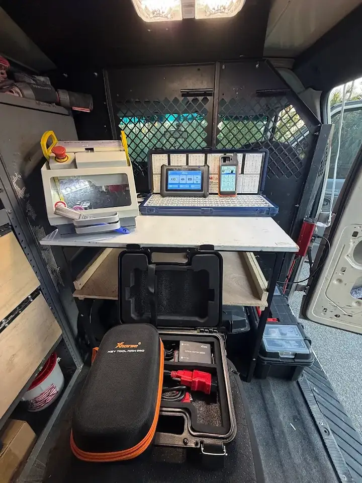 Key cutting machine and key programming tablets inside the mobile locksmith van serving North Port, FL